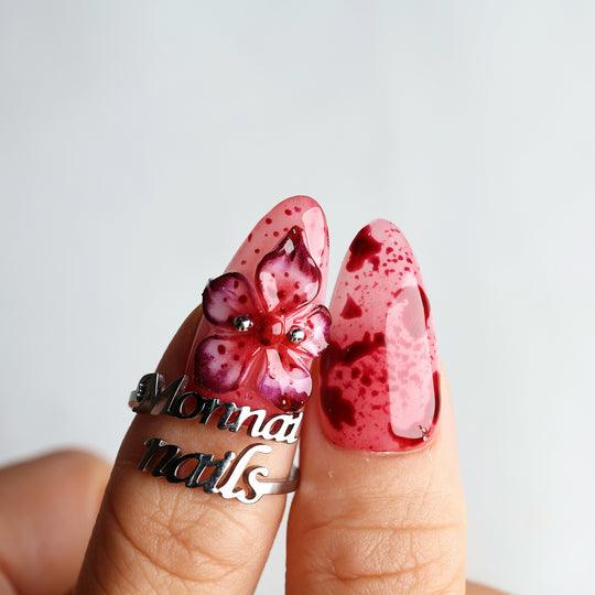 999 Roses press-on nails in close-up, pink with red splatter and 3D gothic flower details
