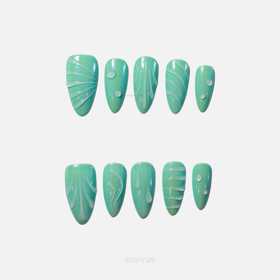 Aqua Glow press-on nails in soft teal, shown laid out with glossy sculpted lines and small droplet details.