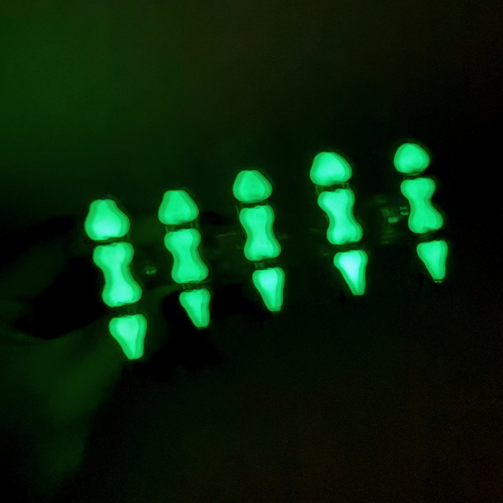 Bad to the Bone glow-in-the-dark press-on nails with green bone segments in a gothic close-up