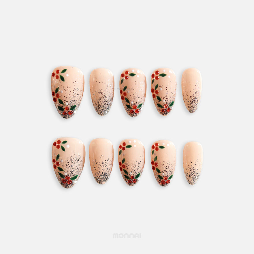 Berry Frost Christmas-themed press-on nails laid out, showing nude bases, silver glitter gradients, and berry vine accents.