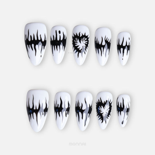 Black or White press-on nails with black melting spikes, heart motifs, and a glossy finish shown laid out.
