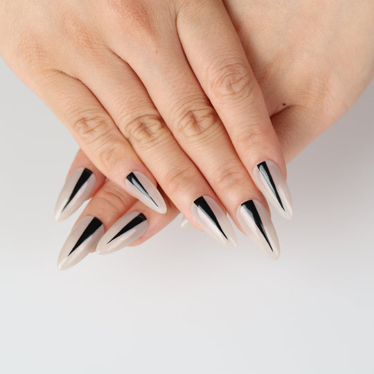 Black Dagger press on nails featuring a tapered black stripe on a creamy nude base with a glossy finish.
