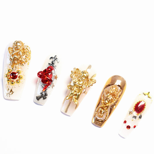Blood Oath press-on nails with gothic cathedrals style, gold cherubs, ruby jewels, and metallic framing laid out in close-up.