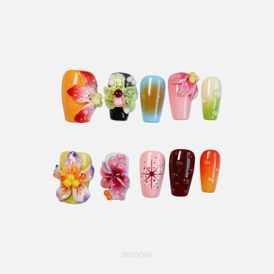 Blooming Paradise press-on nails shown laid out with bright floral 3D designs, glossy dewdrops, and retro star accents.