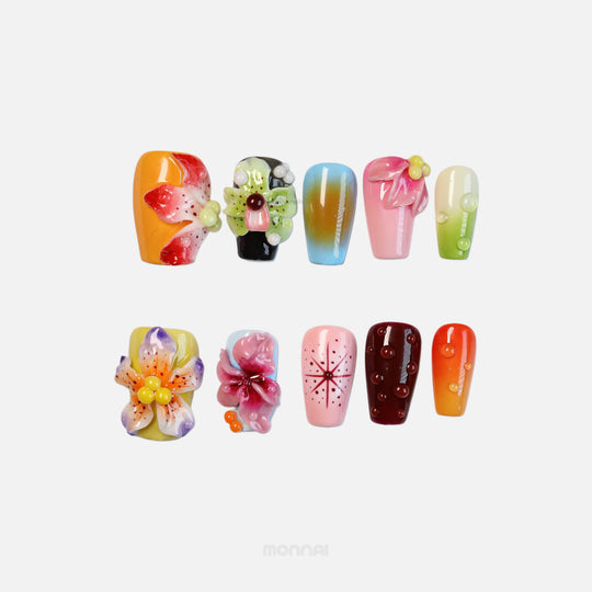 Blooming Paradise press-on nails shown laid out with bright floral 3D designs, glossy dewdrops, and retro star accents.