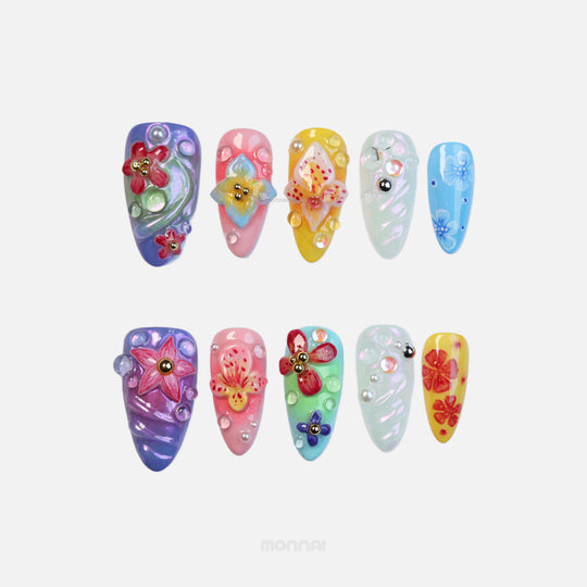 Blossom Fantasy press-on nails laid out, pastel floral nail art with 3D flowers, dewdrops and pearl accents