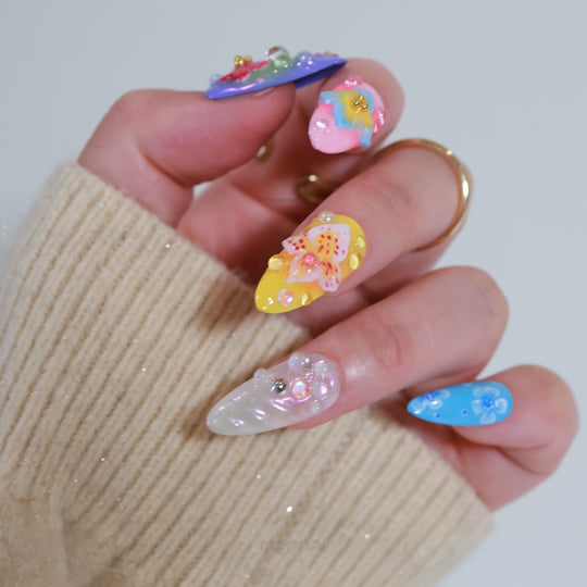 Blossom Fantasy press-on nails in close-up, with pastel floral art, 3D flowers, pearl accents, and dewdrop details.