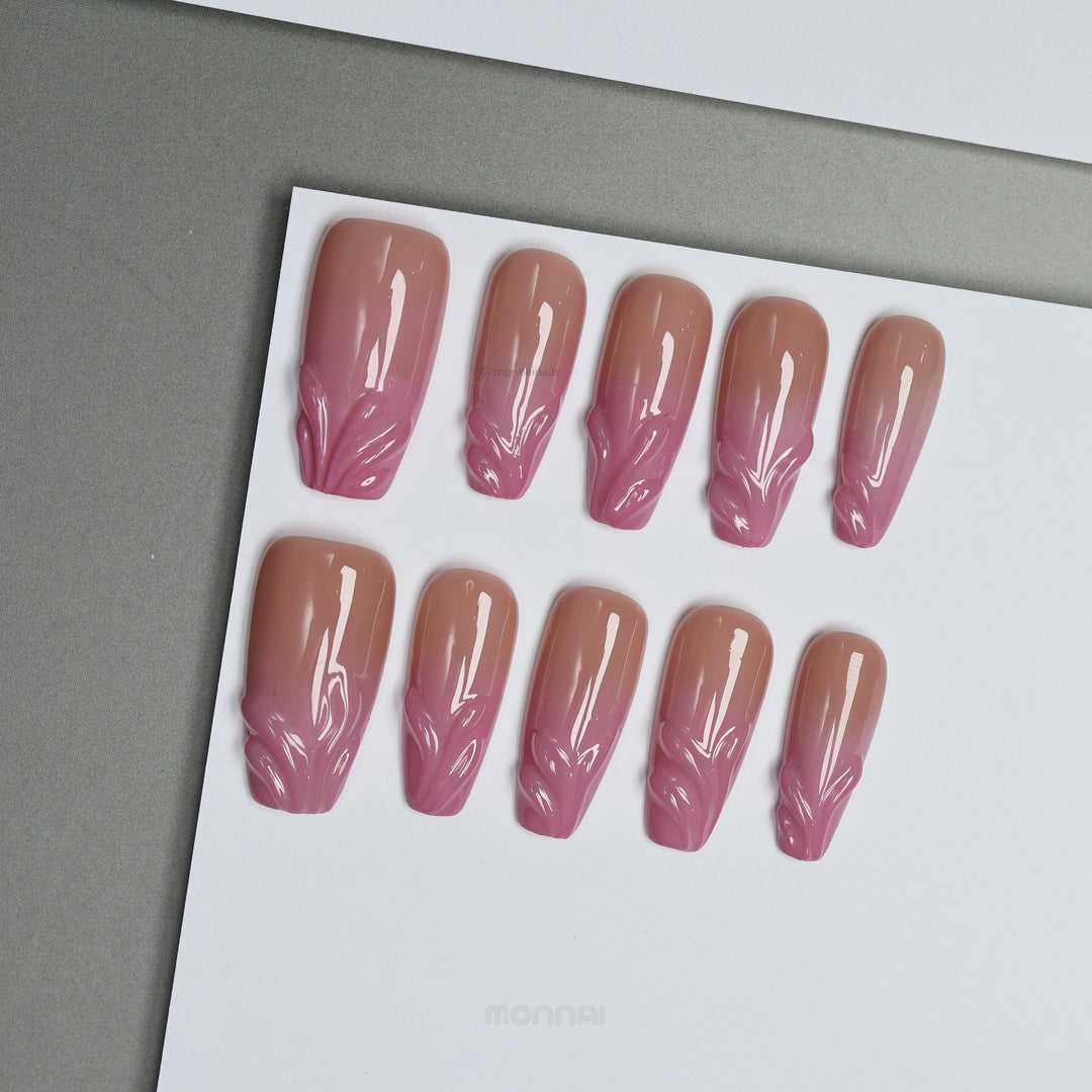 Blush Swirl press-on nails on display, soft nude-to-pink fade with raised gel details at the tips