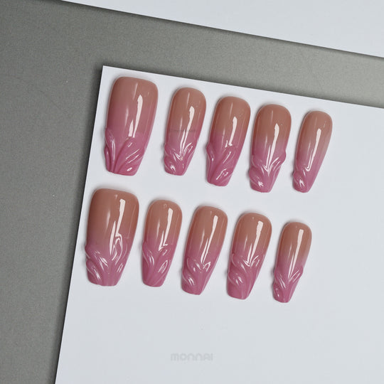 Blush Swirl press-on nails on display, soft nude-to-pink fade with raised gel details at the tips