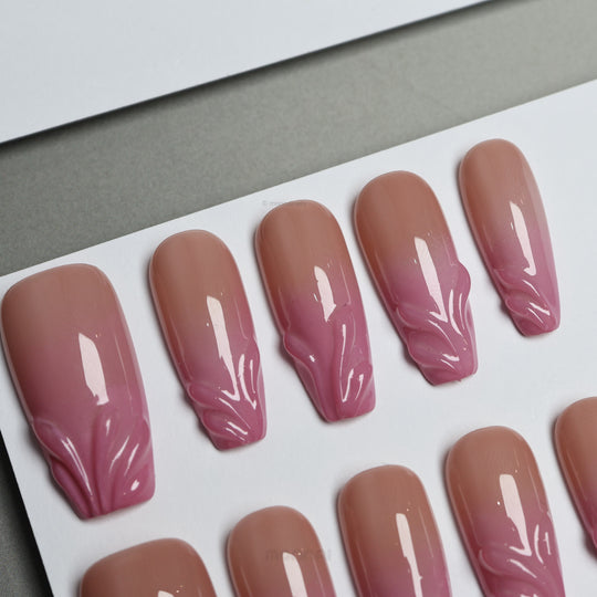 Blush Swirl press-on nails with sheer nude-to-pink fade and raised gel tips, laid out in close-up