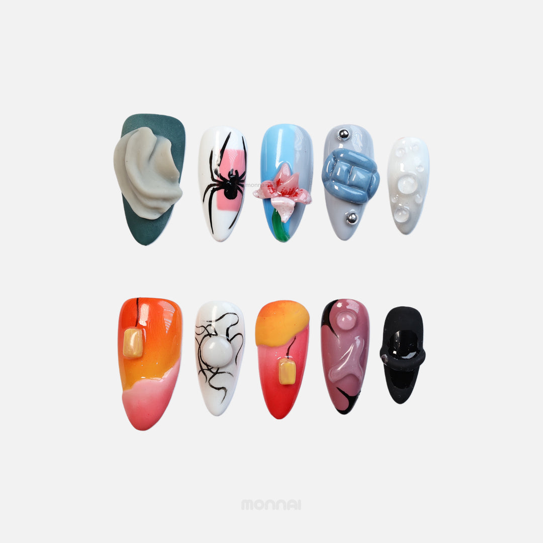 Bold Fantasy press-on nails laid out in indie maximalism with spider art, 3D flower, gel blocks and matte folds.