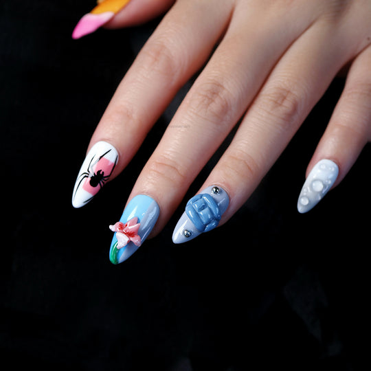 Bold Fantasy press-on nails worn on hand, with hand-painted spider art, 3D flower, blue gel block and bubble accents.
