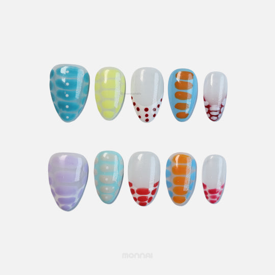 Bold Vibes press-on nails laid out in colorful crocodile-print and glossy polka dot patterns.