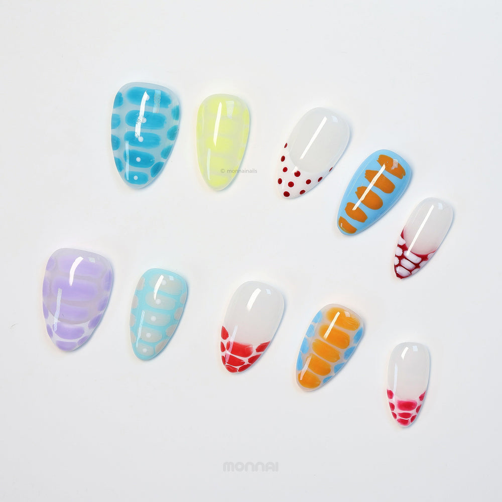 Bold Vibes press-on nails laid out in colorful crocodile-print patterns with glossy polka dots and soft gradients.