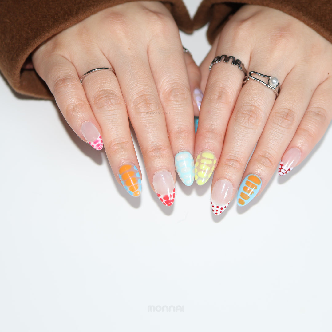 Bold Vibes press-on nails on hands, with colorful crocodile-print patterns, glossy polka dots, and soft gradients.