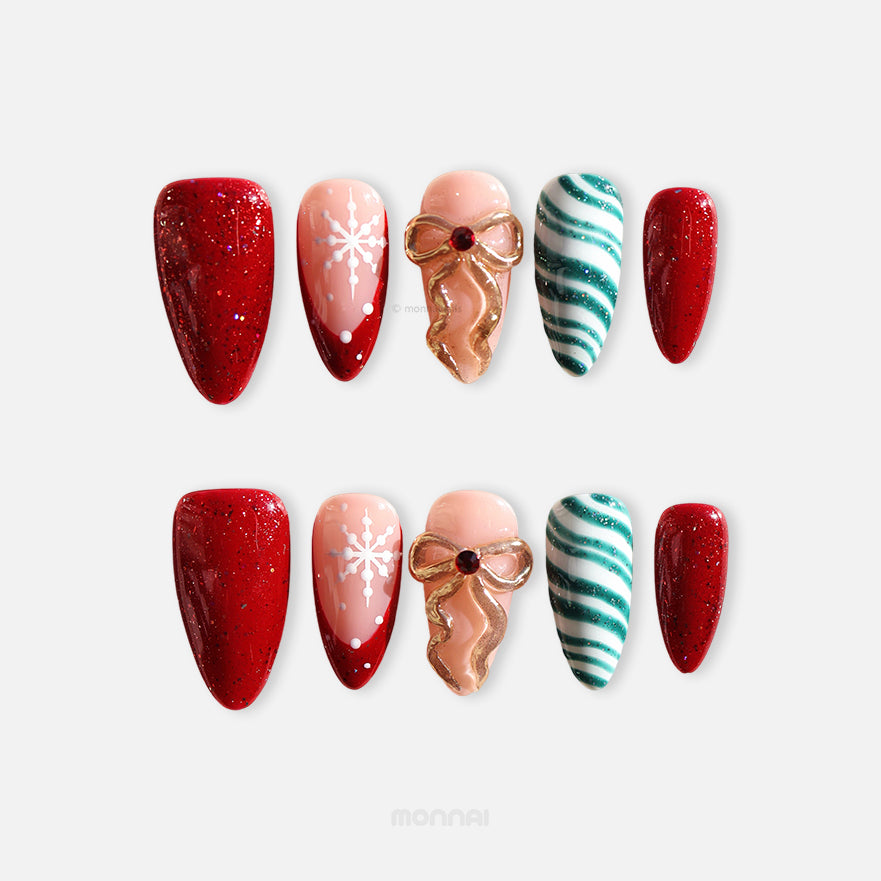 Candy Ribbon press-on nails laid out in red glitter, snowflake, gold bow, and teal striped designs