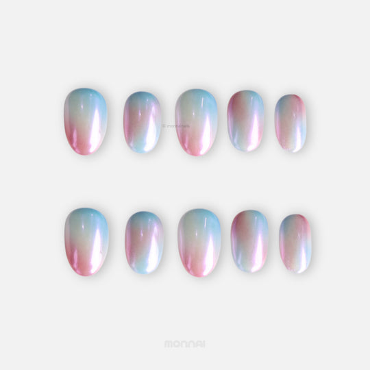 Candy Sky press-on nails shown in two rows, featuring pastel blue-to-peach ombre with an iridescent pearl shine.