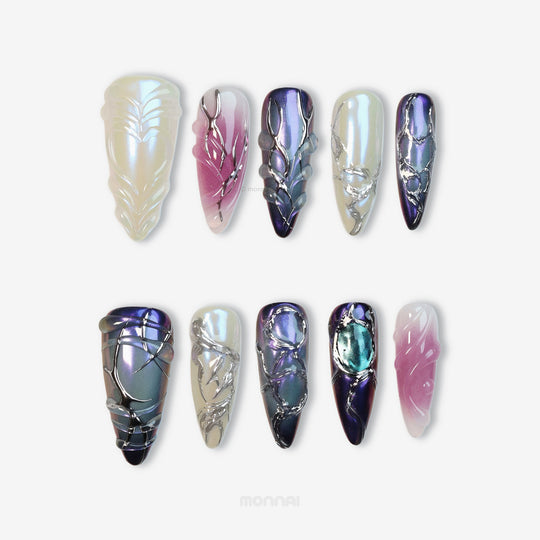 Celestial Aurora press-on nails set shown laid out, with iridescent white, violet-blue and soft pink sculpted chrome details.