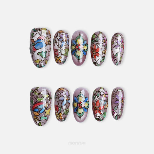 Chapel Garden press-on nails laid out in a stained-glass floral design with jewel-toned mosaic details.