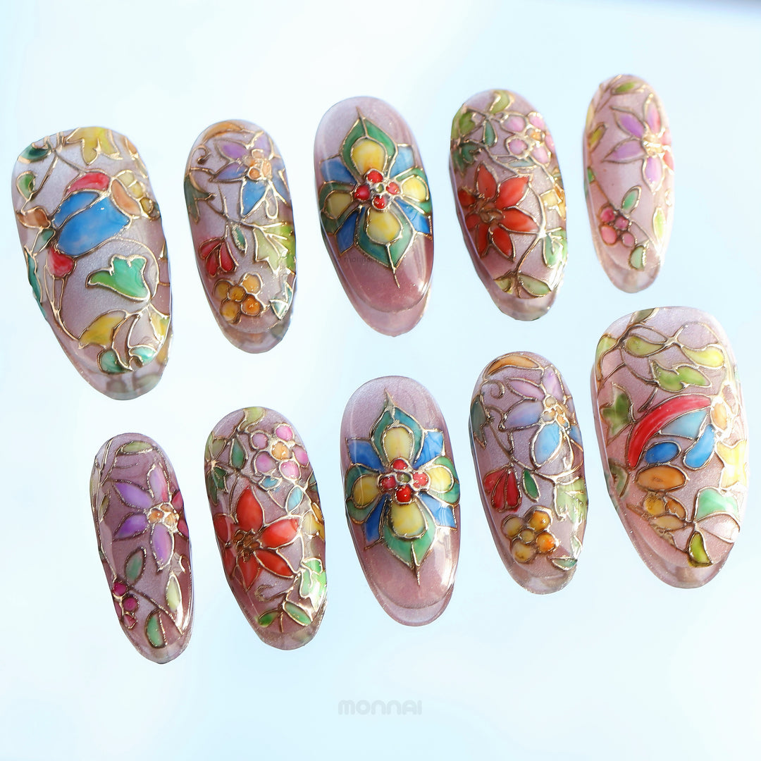 Chapel Garden press-on nails with stained-glass floral mosaic details, shown laid out in close-up
