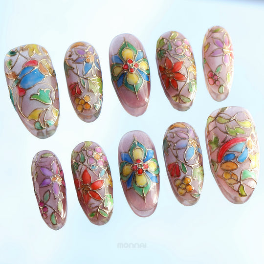 Chapel Garden press-on nails with stained-glass floral mosaic details, shown laid out in close-up
