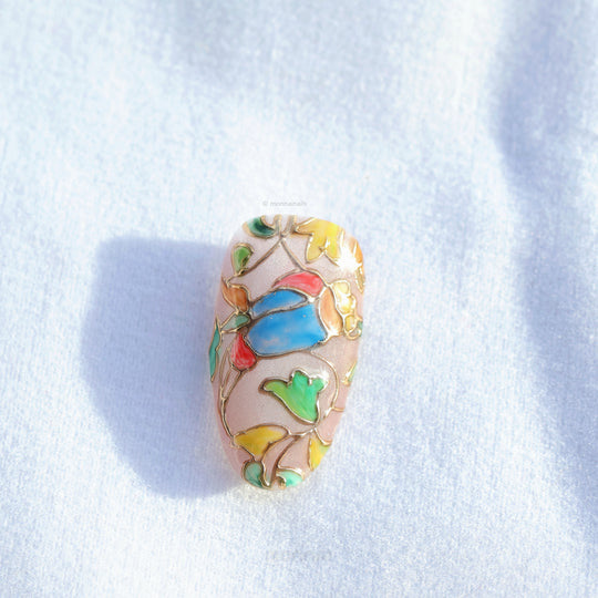 Chapel Garden press-on nails close-up, stained-glass floral mosaic with blue, green and yellow panels