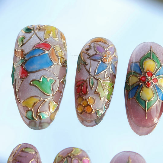 Chapel Garden press-on nails with stained-glass floral mosaic designs in jewel tones on a shimmer base