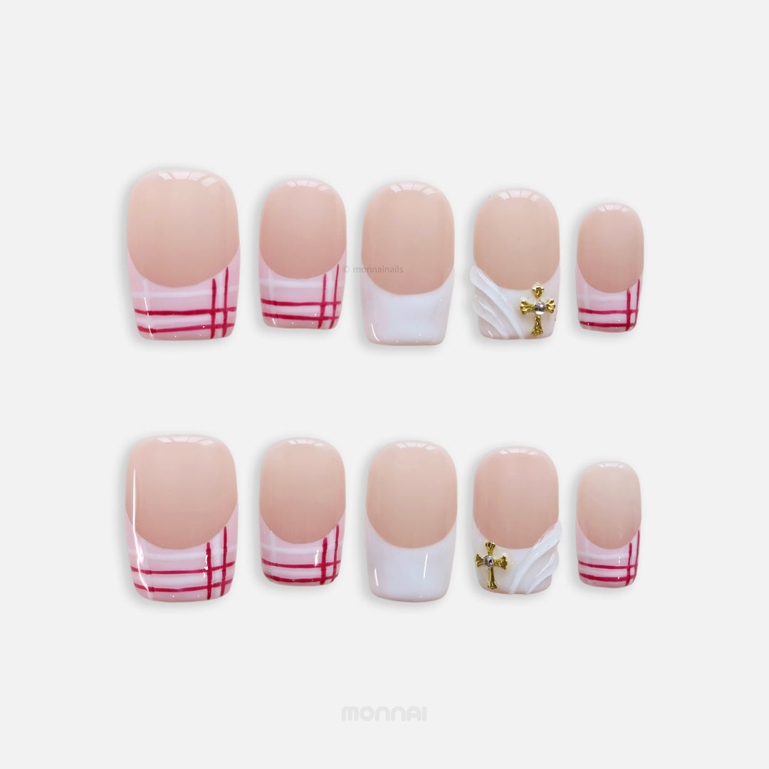 Cherry Check press-on nails shown laid out, featuring preppy plaid tips, a 3D white wave accent, and a gold cross charm.