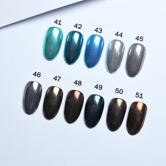 Chrome • 51 Colors Available press-on nails in teal, blue, silver and dark metallic shades, laid out and numbered 41-51.