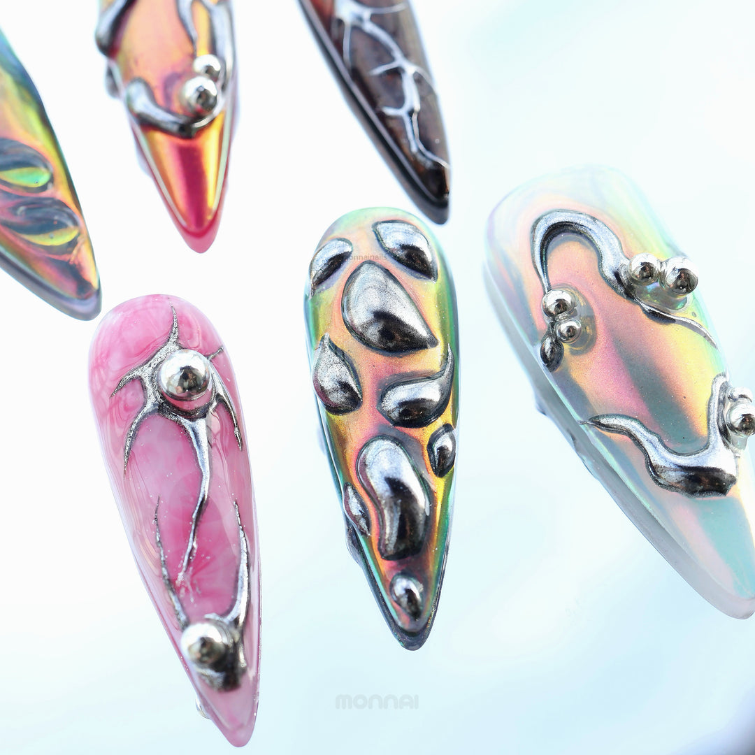 Chrome Wave press-on nails in close-up, showing iridescent chrome flow with raised metallic details and bold futuristic tones.