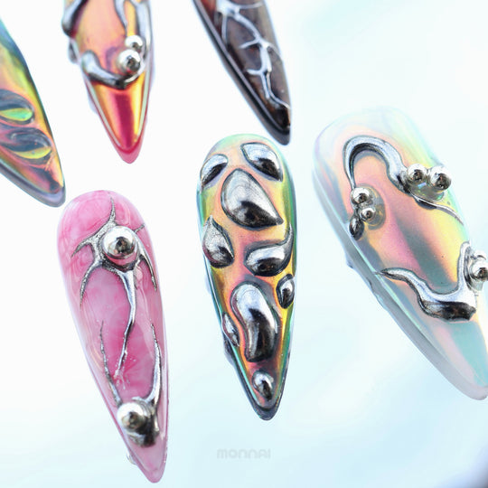Chrome Wave press-on nails in close-up, showing iridescent chrome flow with raised metallic details and bold futuristic tones.