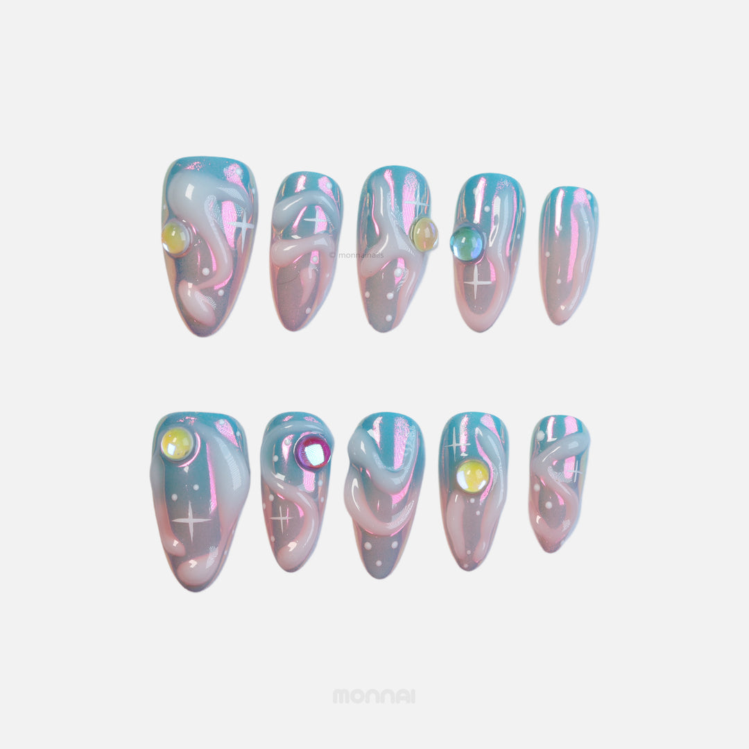 Cloud Dream press-on nails with blue-to-pink aura, chrome shine, and rounded gem accents in a dreamy futuristic set