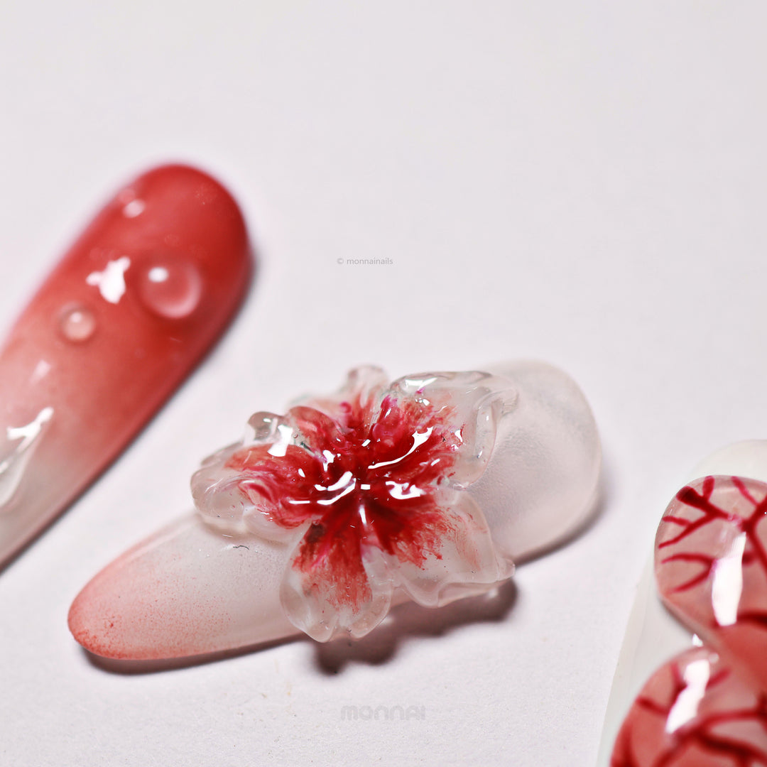 Crimson Bloom press-on nails close-up with blood red ombre and translucent 3D flower detail