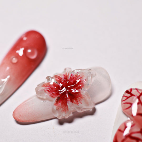 Crimson Bloom press-on nails close-up with blood red ombre and translucent 3D flower detail