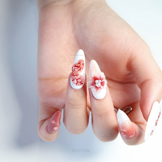 Crimson Bloom press-on nails worn on hand, showing blood red vein art and a translucent flower with pearls.