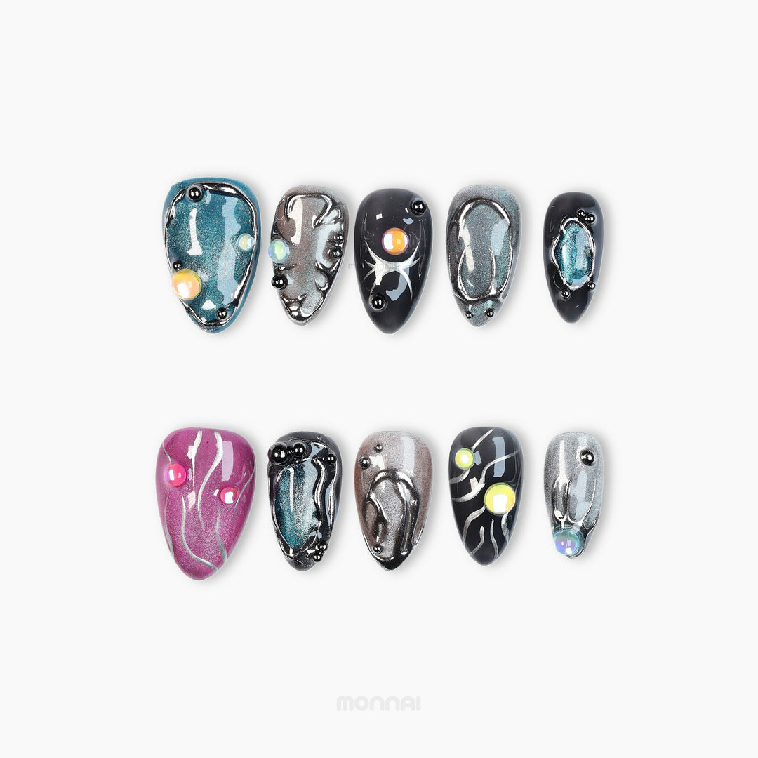Cyber Galaxy press-on nails laid out in mixed cosmic shimmer with chrome details and celestial accents