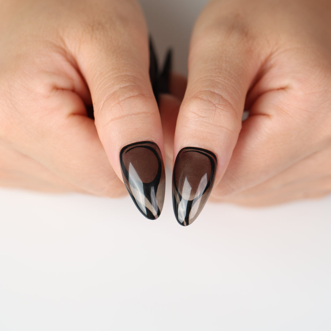 Dark Current press on nails with sheer smoky gray base, glossy black curves, and modern minimalist finish