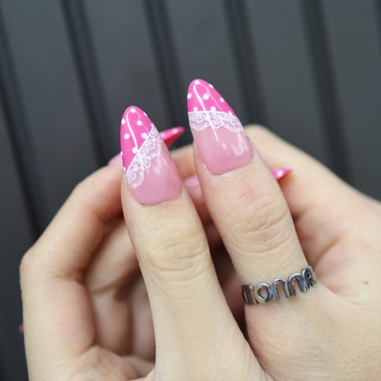 Dot &amp; Lace press-on nails on hand, soft pink with magenta tips, white lace and polka dots, glossy finish