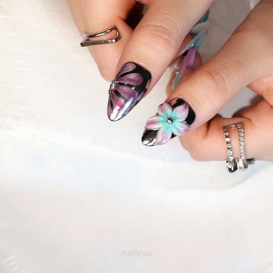 Enchanted Love press-on nails worn on hand with chrome accents, purple floral detail and mint-pink flower motif