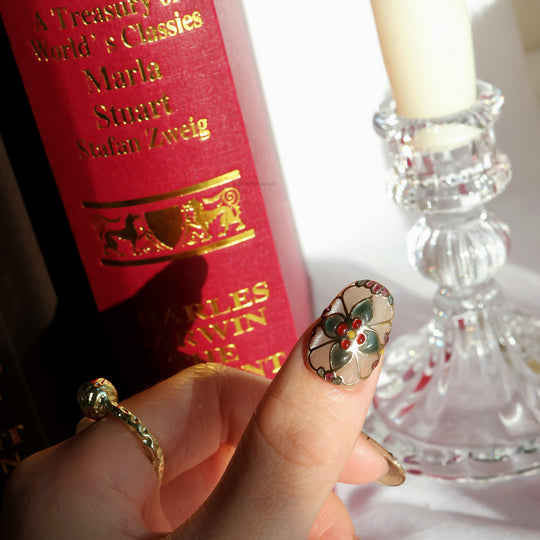 Eternal Grace press-on nails shown worn on hand, with vintage stained-glass florals in champagne-gold and jewel accents.