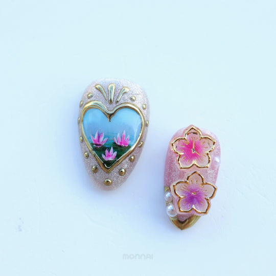 Ethereal Reverie press-on nails laid out, with a heart scene and floral accents in gold-framed pastel shimmer.