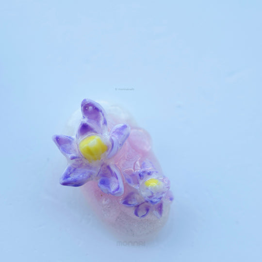 Fairy Pond press-on nails in close-up with raised purple lotus and water lily details on a sheer pastel base
