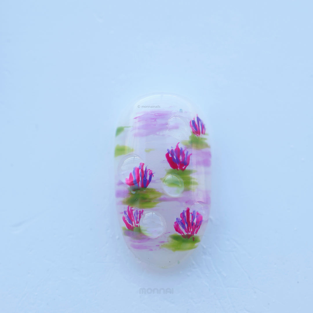 Fairy Pond press-on nails shown in close-up with pastel lotus and water lily details, glossy water drops, and dreamy soft pink and green accents