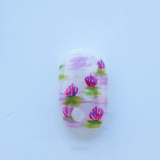 Fairy Pond press-on nails shown in close-up with pastel lotus and water lily details, glossy water drops, and dreamy soft pink and green accents