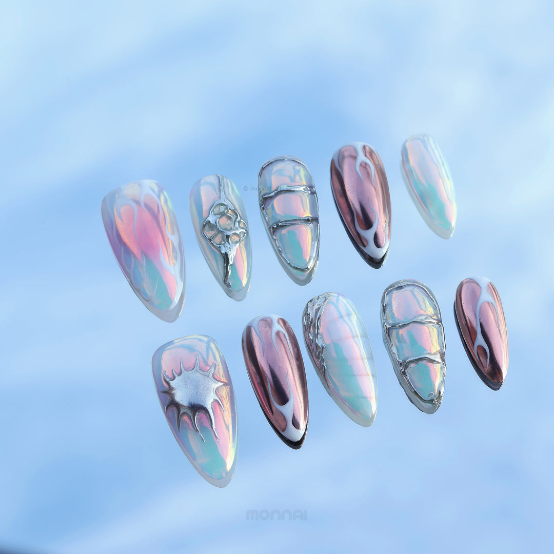 Flame Gradient press-on nails laid out with icy blue chrome accents and flame-inspired glossy detailing