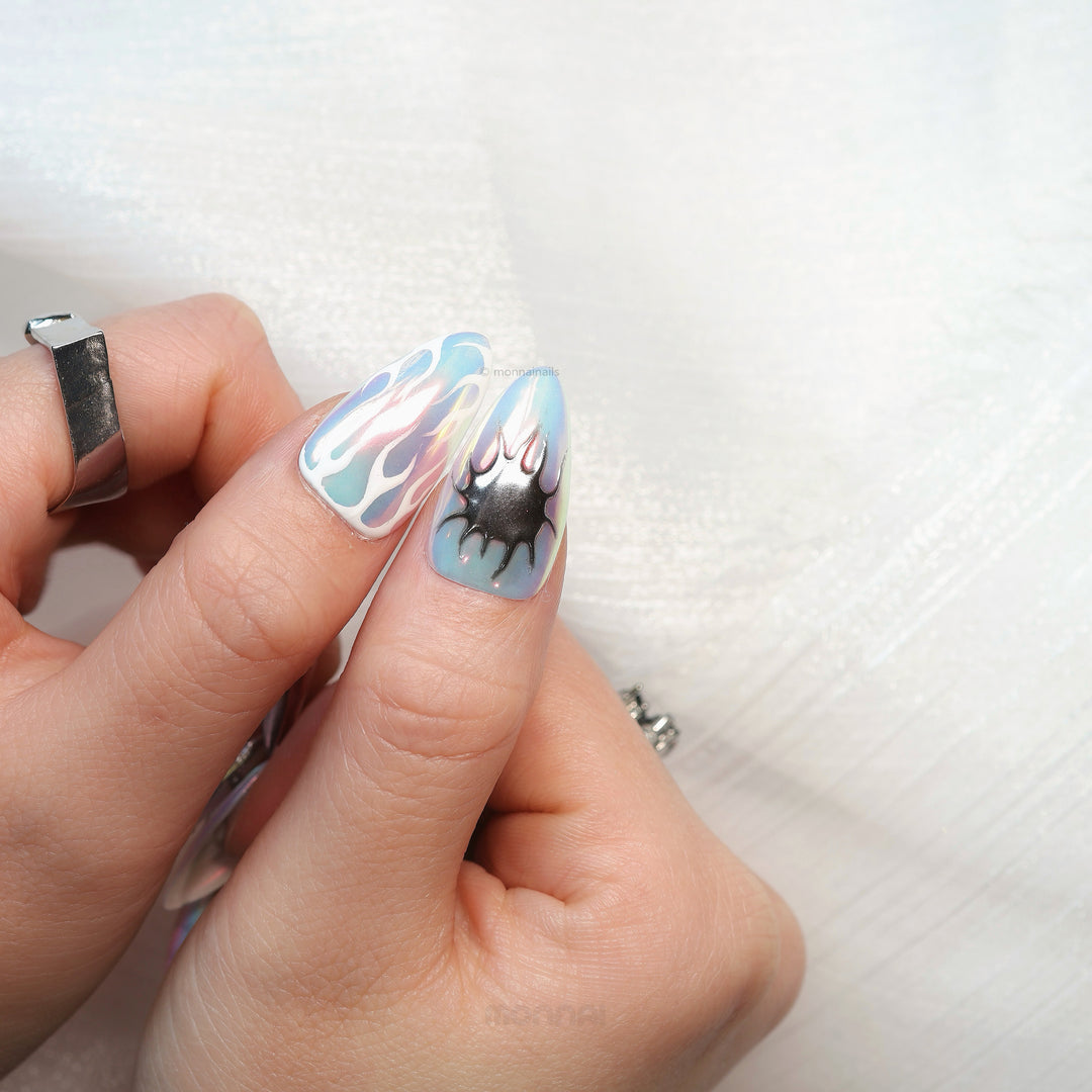 Flame Gradient press-on nails on hand with icy blue chrome flame detailing and glossy futuristic finish