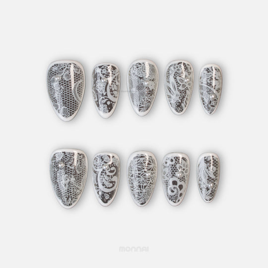 Floral Veil press-on nails laid out, showing sheer white vintage floral lace and micro pearls.