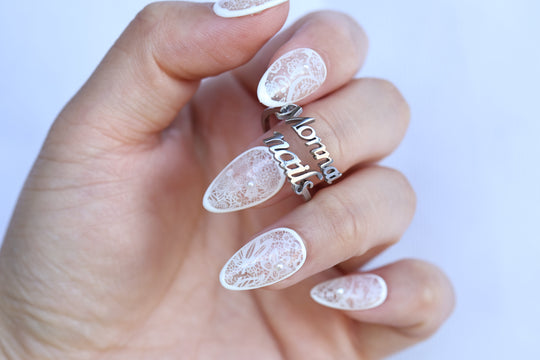 Floral Veil press-on nails worn on hand, white floral lace over sheer base with micro pearls
