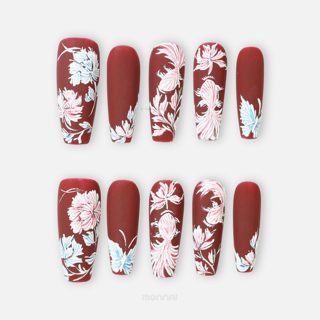 Flutter & Flow press-on nails in deep burgundy matte with hand-painted floral embroidery style