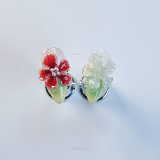 Frost Bloom press-on nails with glossy 3D florals, red and clear petals, pearl centers, shown in close-up